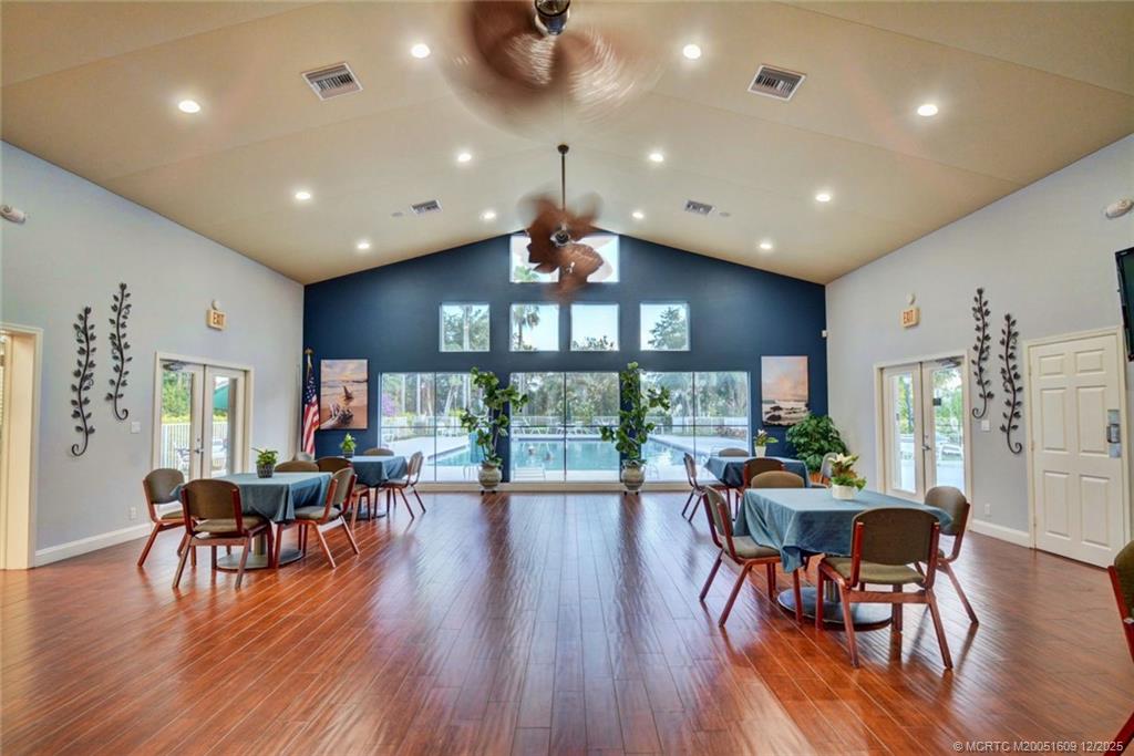 6789 Southeast Warwick Lane Stuart, FL 34997 - Photo 23 of 24 a view of a dining room with furniture window and wooden floor