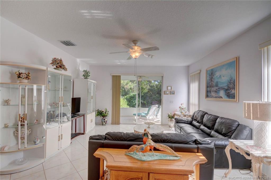6789 Southeast Warwick Lane Stuart, FL 34997 - Photo 4 of 24 a living room with furniture and a large window