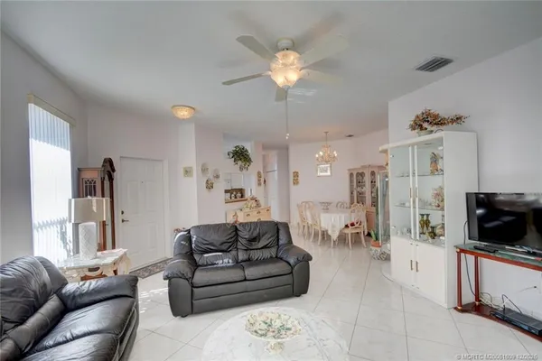 a dining room with furniture and chandelier