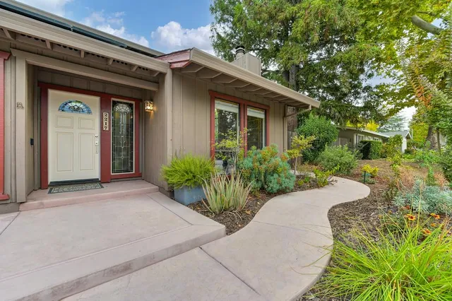 a living room with furniture a fireplace and a large window