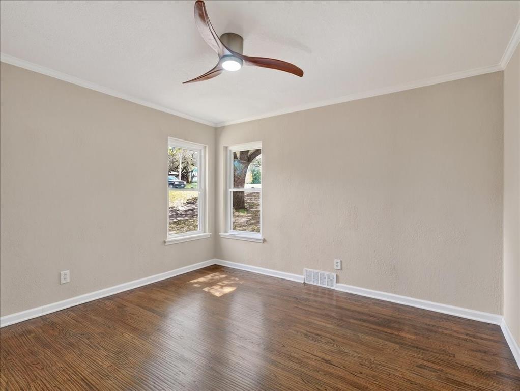 3863 Clayton Road East Fort Worth, TX 76116 - Photo 27 of 39 an empty room with wooden floor chandelier fan and windows