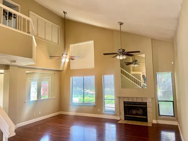 a view of a livingroom with furniture a fireplace and wooden floor