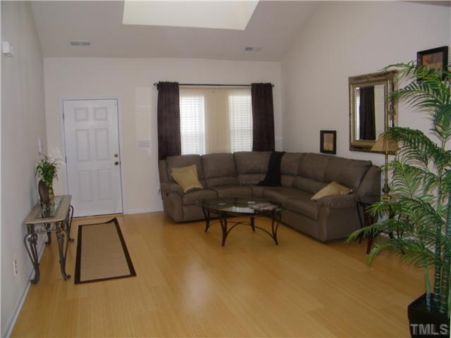 7116 Missionary Ridge Drive Raleigh, NC 27610 - Photo 3 of 12 a living room with furniture and a potted plant