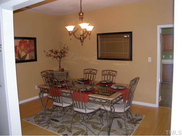 7116 Missionary Ridge Drive Raleigh, NC 27610 - Photo 5 of 12 a view of a dining room with furniture and chandelier