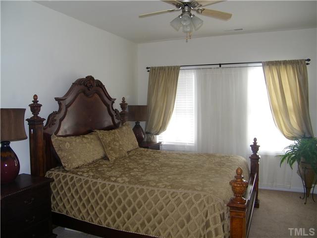 7116 Missionary Ridge Drive Raleigh, NC 27610 - Photo 8 of 12 a bedroom with a bed and window