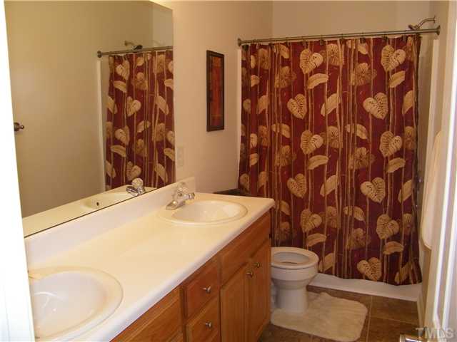 7116 Missionary Ridge Drive Raleigh, NC 27610 - Photo 9 of 12 a bathroom with a granite countertop sink and a toilet