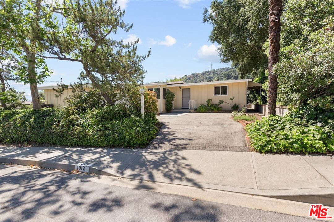 a view of a house with a yard and tree s