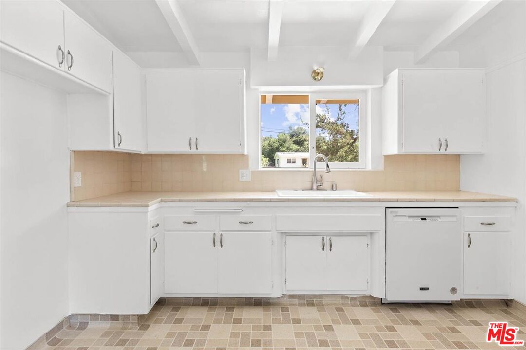 1012 Camann Street Glendale, CA 91208 - Photo 8 of 33 a kitchen with granite countertop white cabinets and a window