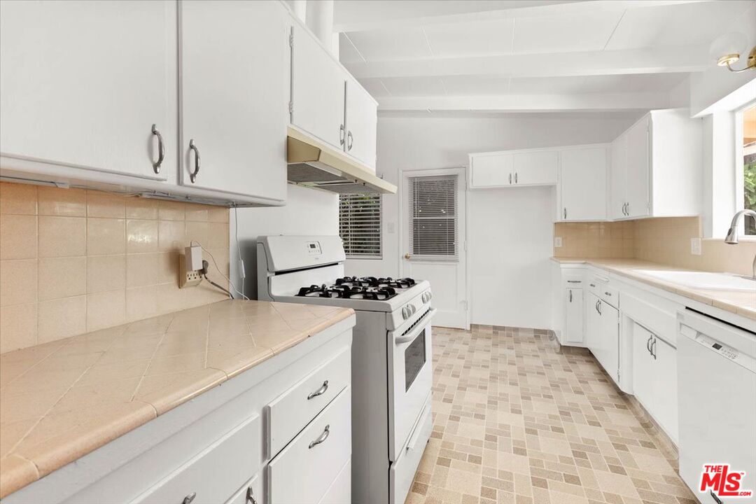 1012 Camann Street Glendale, CA 91208 - Photo 10 of 33 a kitchen with stainless steel appliances a refrigerator a sink a stove and white cabinets
