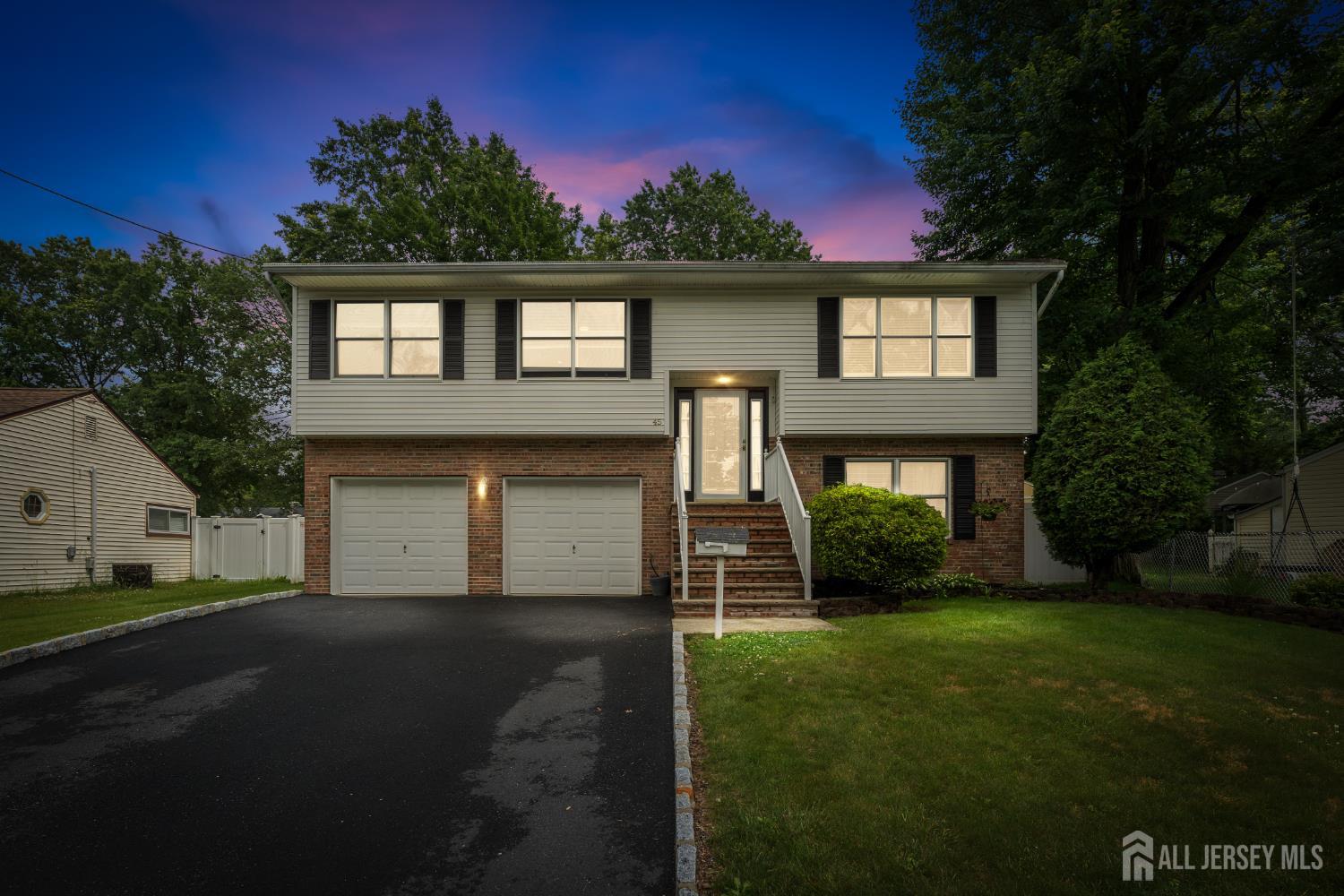 45 Kenmore Road Edison, NJ 08817 - Photo 1 of 43 a front view of a house with a yard and garage