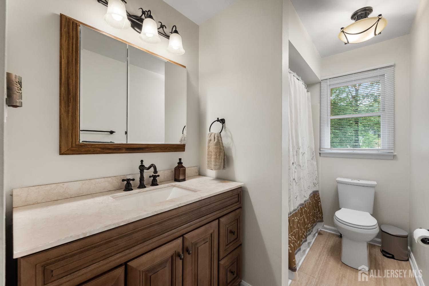 45 Kenmore Road Edison, NJ 08817 - Photo 20 of 43 a bathroom with a toilet sink and mirror