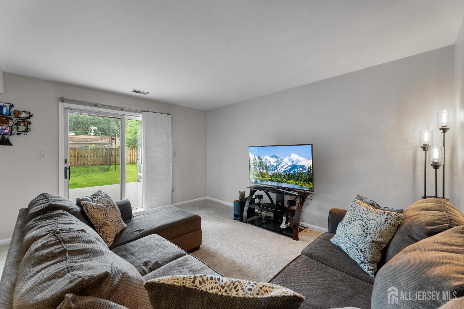45 Kenmore Road Edison, NJ 08817 - Photo 23 of 43 a living room with furniture and a flat screen tv