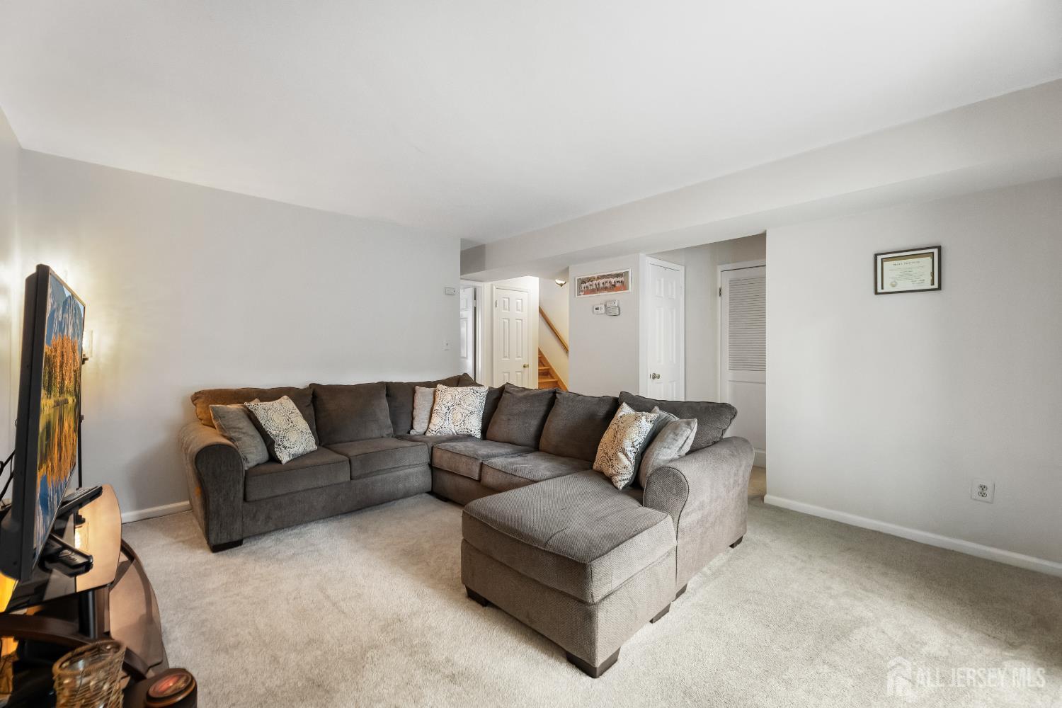 45 Kenmore Road Edison, NJ 08817 - Photo 24 of 43 a living room with furniture and a flat screen tv
