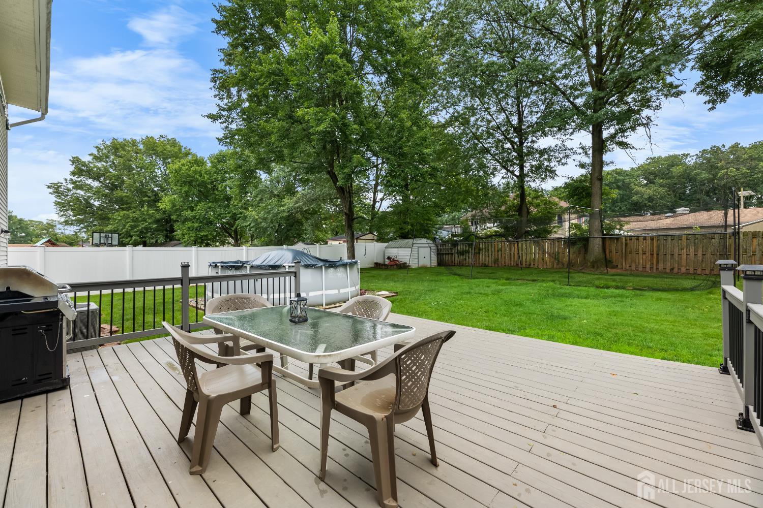 45 Kenmore Road Edison, NJ 08817 - Photo 27 of 43 a view of a chairs and table on the wooden deck