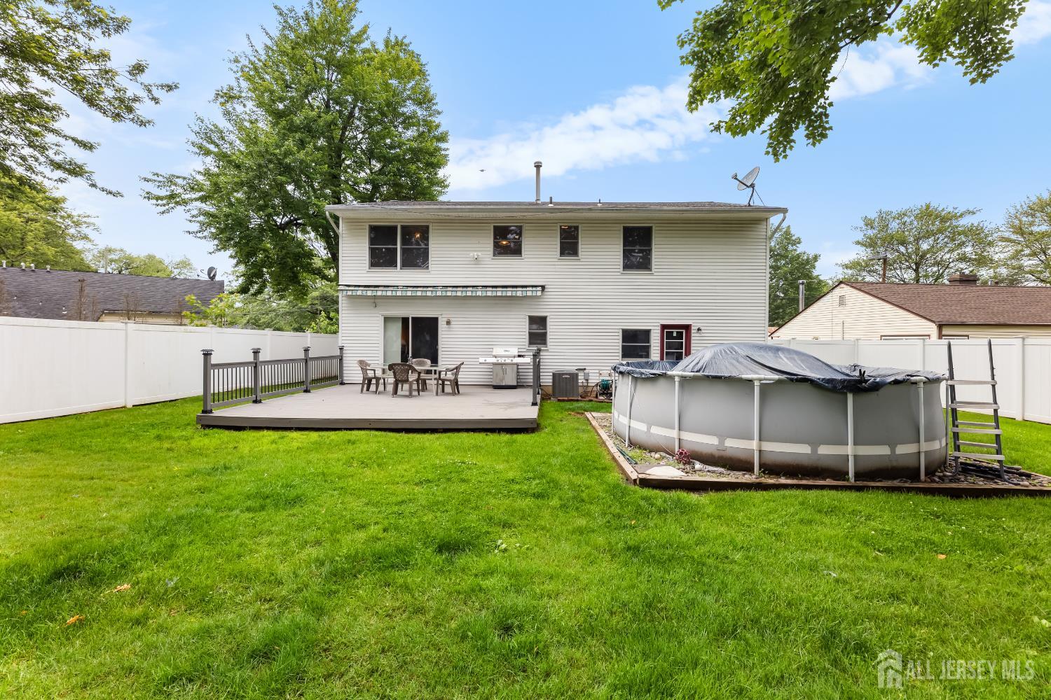 45 Kenmore Road Edison, NJ 08817 - Photo 29 of 43 a view of house with backyard outdoor seating and green space