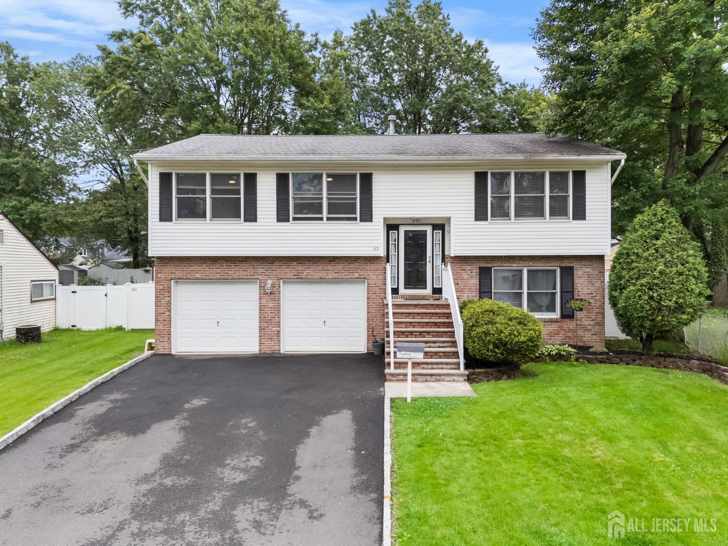 45 Kenmore Road Edison, NJ 08817 - Photo 3 of 43 a front view of a house with a garden and yard