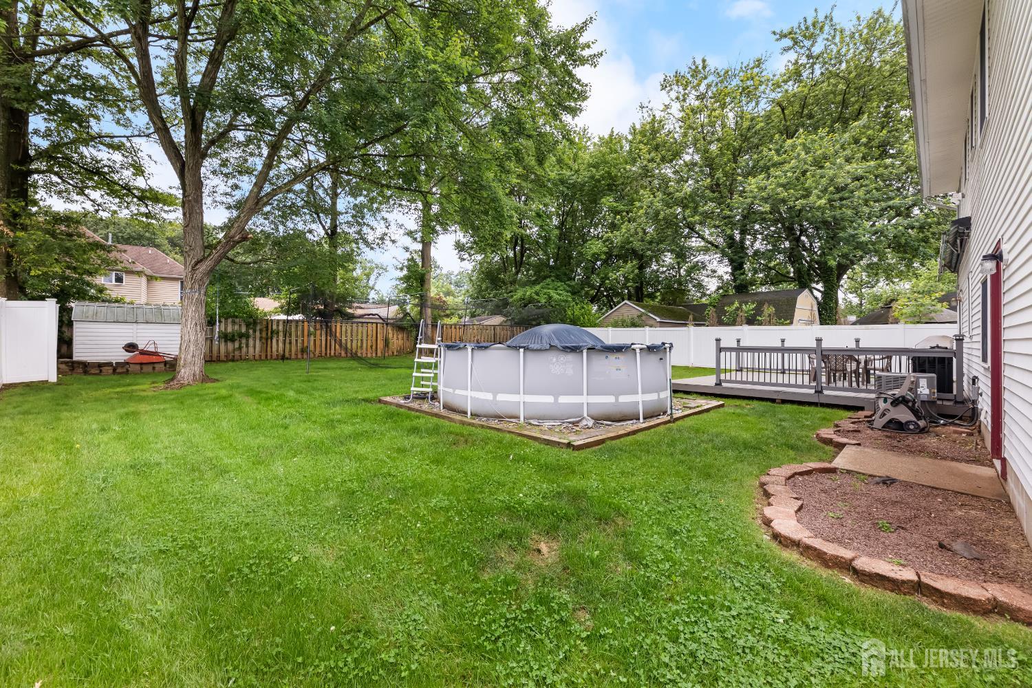 45 Kenmore Road Edison, NJ 08817 - Photo 31 of 43 a view of a backyard with a garden and entertaining space