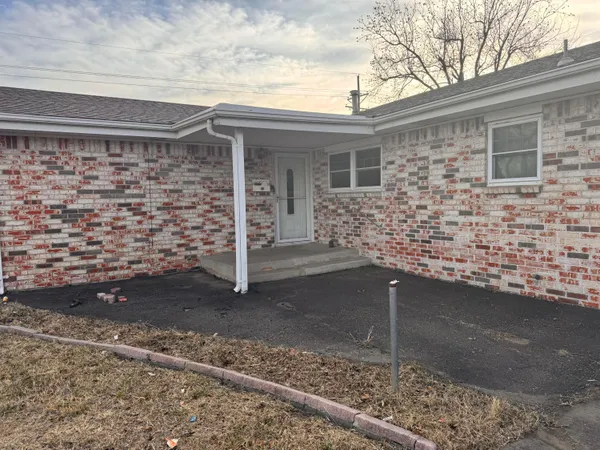 a front view of a house with parking space
