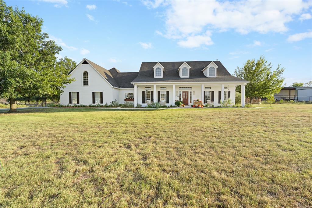 754 Conestoga Trail Rhome, TX 76078 - Photo 1 of 1 Cape cod house with a front lawn and covered porch