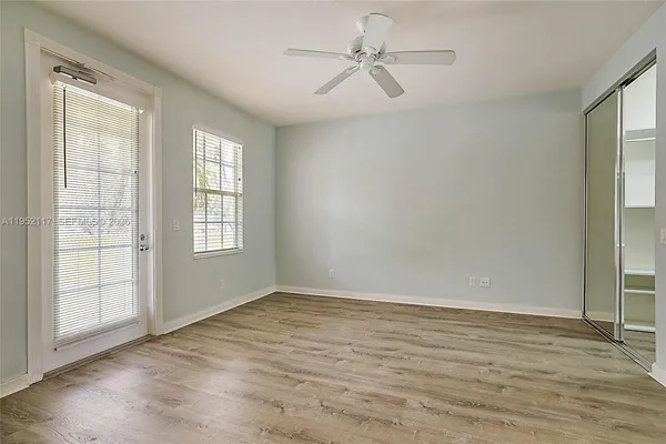 wooden floor in an empty room with a window