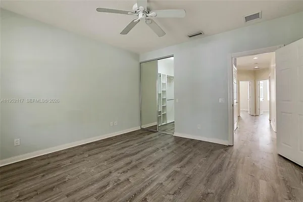 a view of an empty room with wooden floor