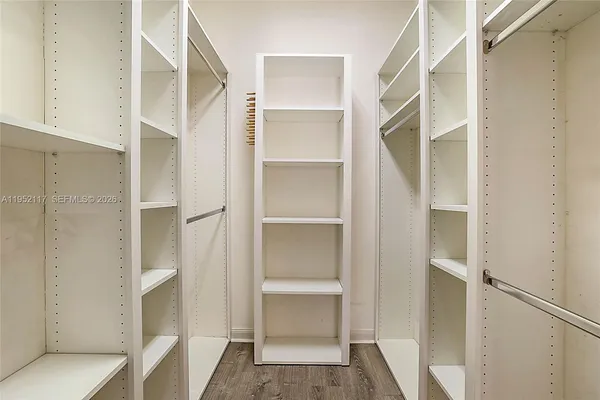 a view of walk in closet with empty racks