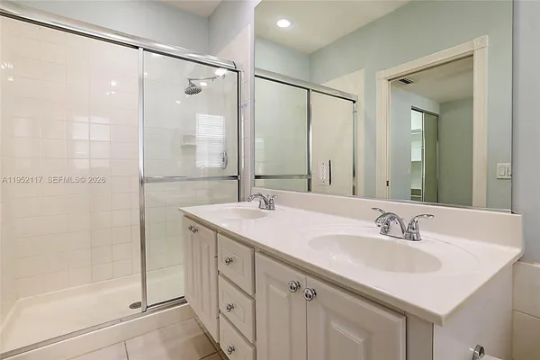 a bathroom with a sink double vanity and shower