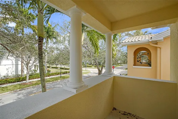 a view of empty room with floor to ceiling window and tree