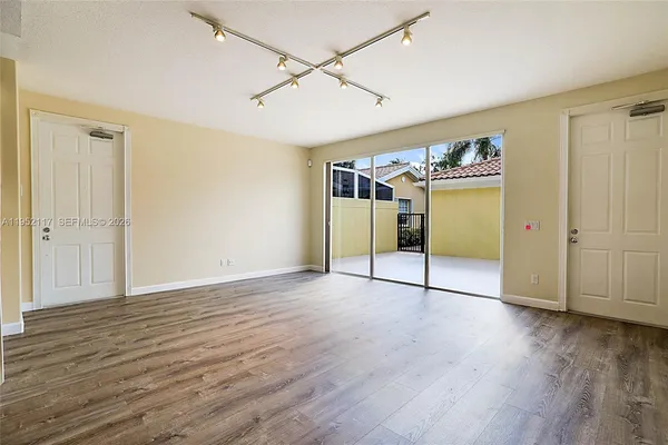 a view of a room with wooden floor