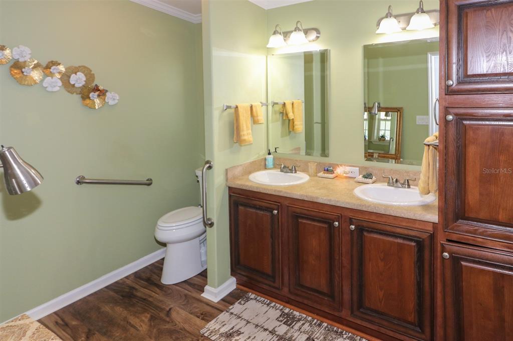 29200 South Jones Loop Road, Unit 715 Punta Gorda, FL 33950 - Photo 18 of 37 a bathroom with a sink a toilet and mirror