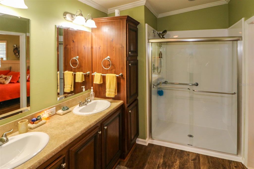 29200 South Jones Loop Road, Unit 715 Punta Gorda, FL 33950 - Photo 19 of 37 a bathroom with a shower sink vanity and mirror