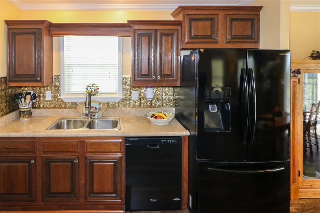 29200 South Jones Loop Road, Unit 715 Punta Gorda, FL 33950 - Photo 24 of 37 a kitchen with stainless steel appliances granite countertop a refrigerator and a sink