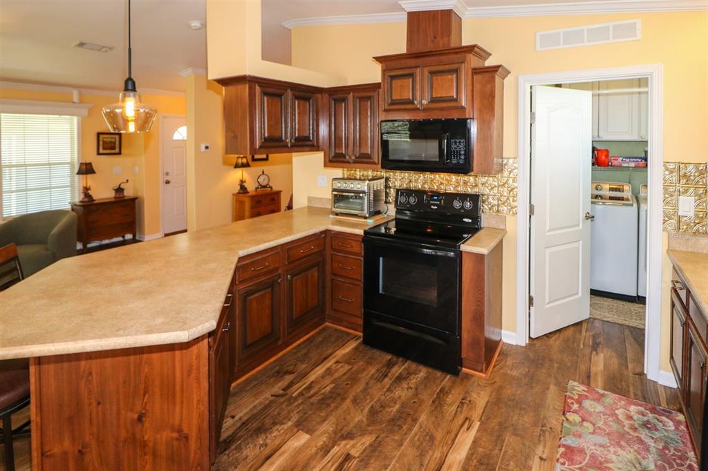 29200 South Jones Loop Road, Unit 715 Punta Gorda, FL 33950 - Photo 25 of 37 a kitchen with stainless steel appliances granite countertop a stove and a refrigerator