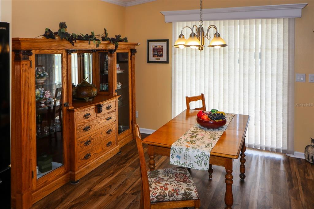 29200 South Jones Loop Road, Unit 715 Punta Gorda, FL 33950 - Photo 27 of 37 a view of a balcony dining area with furniture window and wooden floor