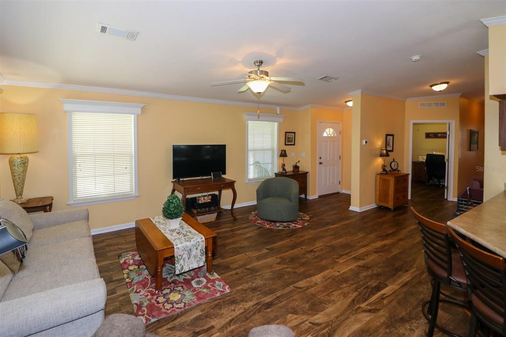 29200 South Jones Loop Road, Unit 715 Punta Gorda, FL 33950 - Photo 3 of 37 a living room with furniture a flat screen tv and a window