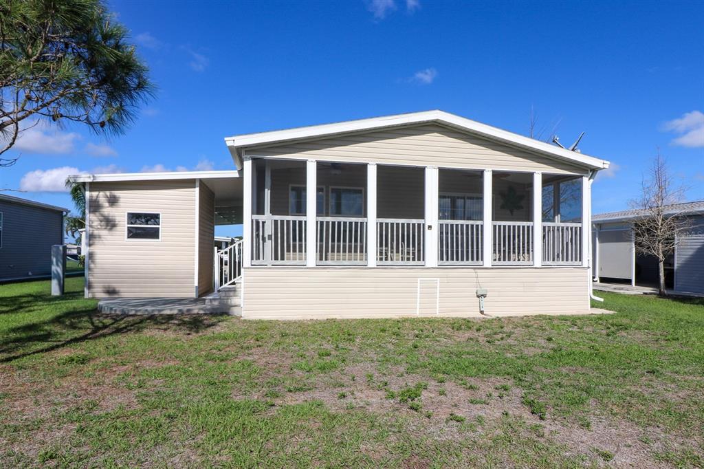 29200 South Jones Loop Road, Unit 715 Punta Gorda, FL 33950 - Photo 31 of 37 a front view of a house with a yard