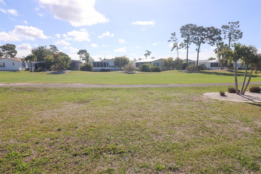 29200 South Jones Loop Road, Unit 715 Punta Gorda, FL 33950 - Photo 32 of 37 a view of a green field with trees