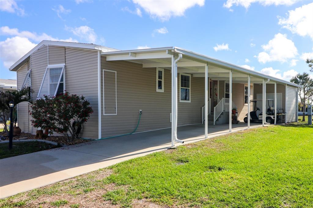 29200 South Jones Loop Road, Unit 715 Punta Gorda, FL 33950 - Photo 33 of 37 a view of a house with backyard and porch