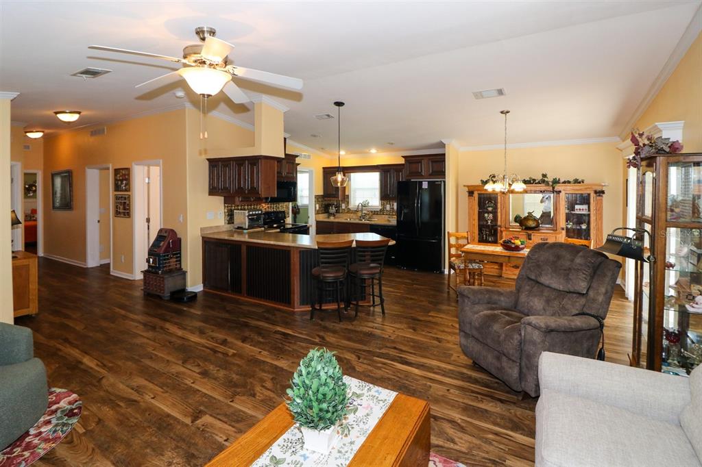 29200 South Jones Loop Road, Unit 715 Punta Gorda, FL 33950 - Photo 4 of 37 a living room with lots of furniture and kitchen view