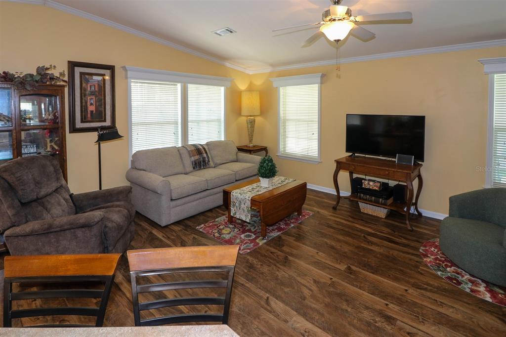 29200 South Jones Loop Road, Unit 715 Punta Gorda, FL 33950 - Photo 5 of 37 a living room with furniture and a flat screen tv