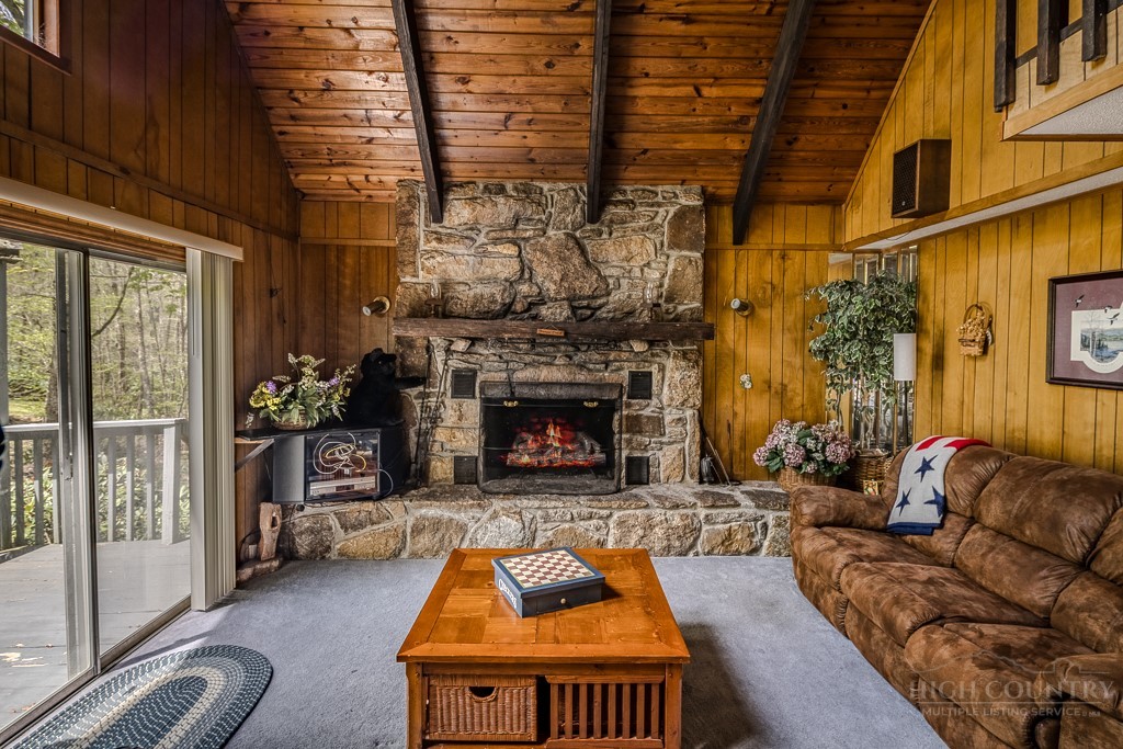 107-109 Shagbark Road Beech Mountain, NC 28604 - Photo 3 of 45 a living room with furniture and a fireplace