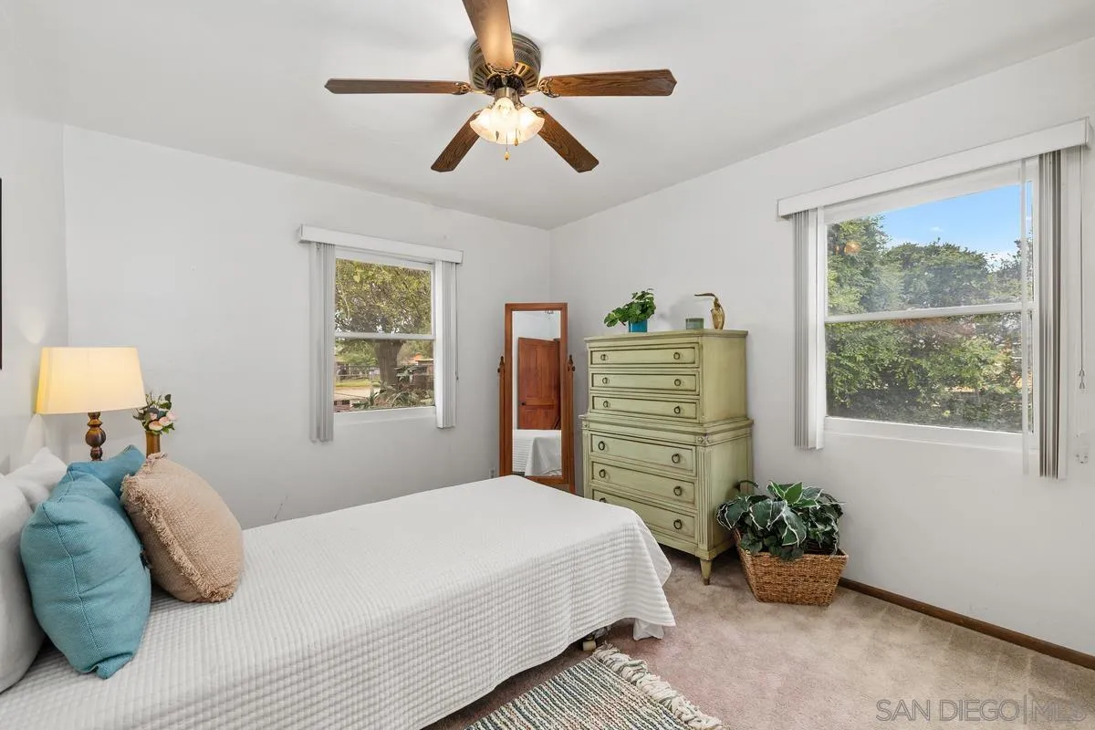 11179 Topo Lane Lakeside, CA 92040 - Photo 21 of 44 a bedroom with a bed and a chandelier