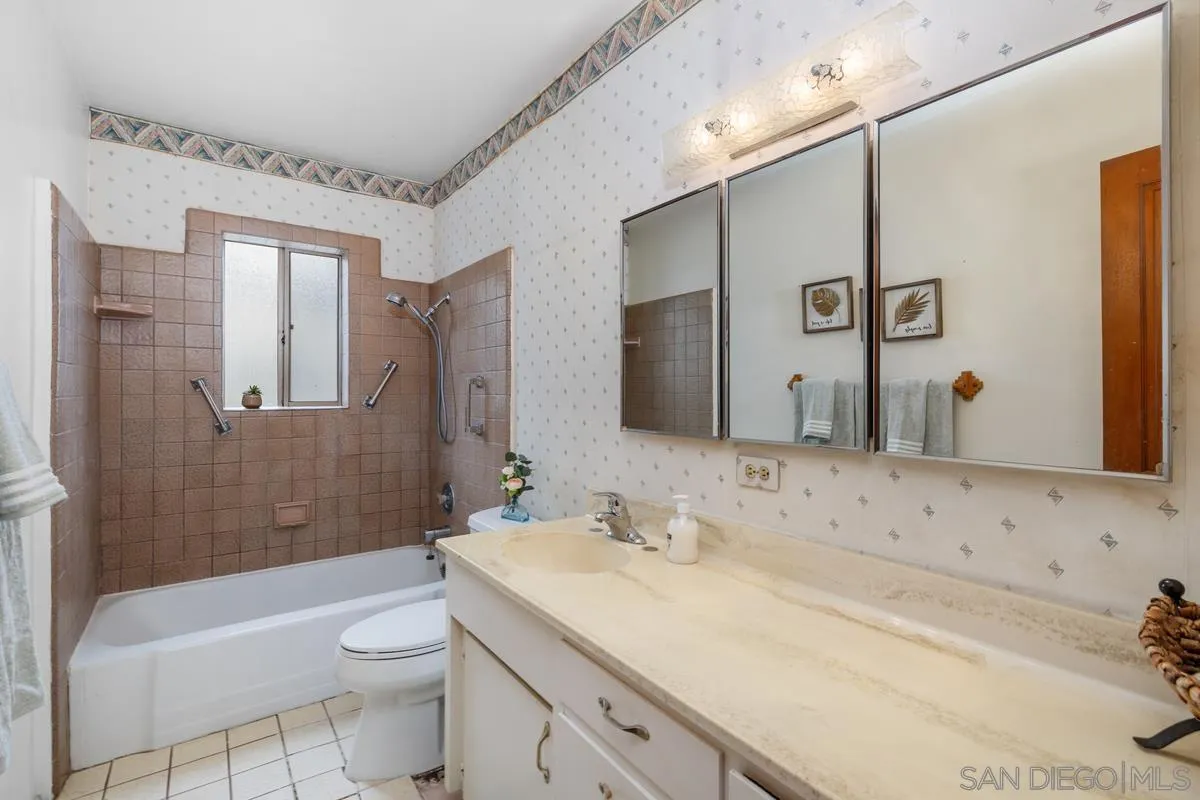 11179 Topo Lane Lakeside, CA 92040 - Photo 23 of 44 a bathroom with a granite countertop sink mirror vanity and toilet