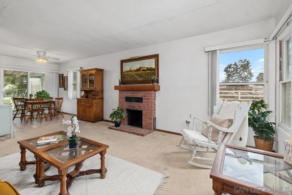 11179 Topo Lane Lakeside, CA 92040 - Photo 7 of 44 a living room with furniture a fireplace and a table