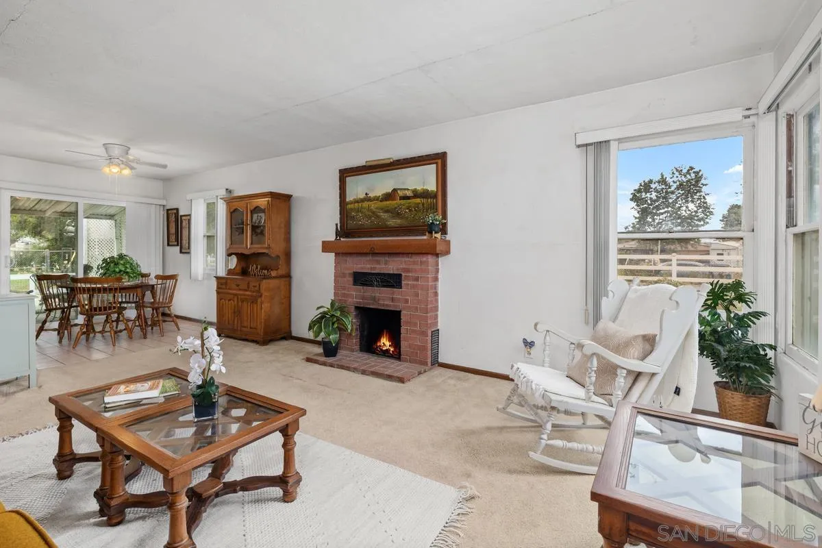 11179 Topo Lane Lakeside, CA 92040 - Photo 8 of 44 a living room with furniture a fireplace and a table