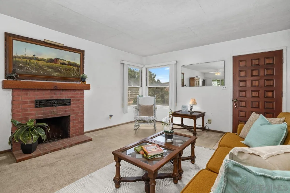 11179 Topo Lane Lakeside, CA 92040 - Photo 9 of 44 a living room with furniture a flat screen tv and a fireplace