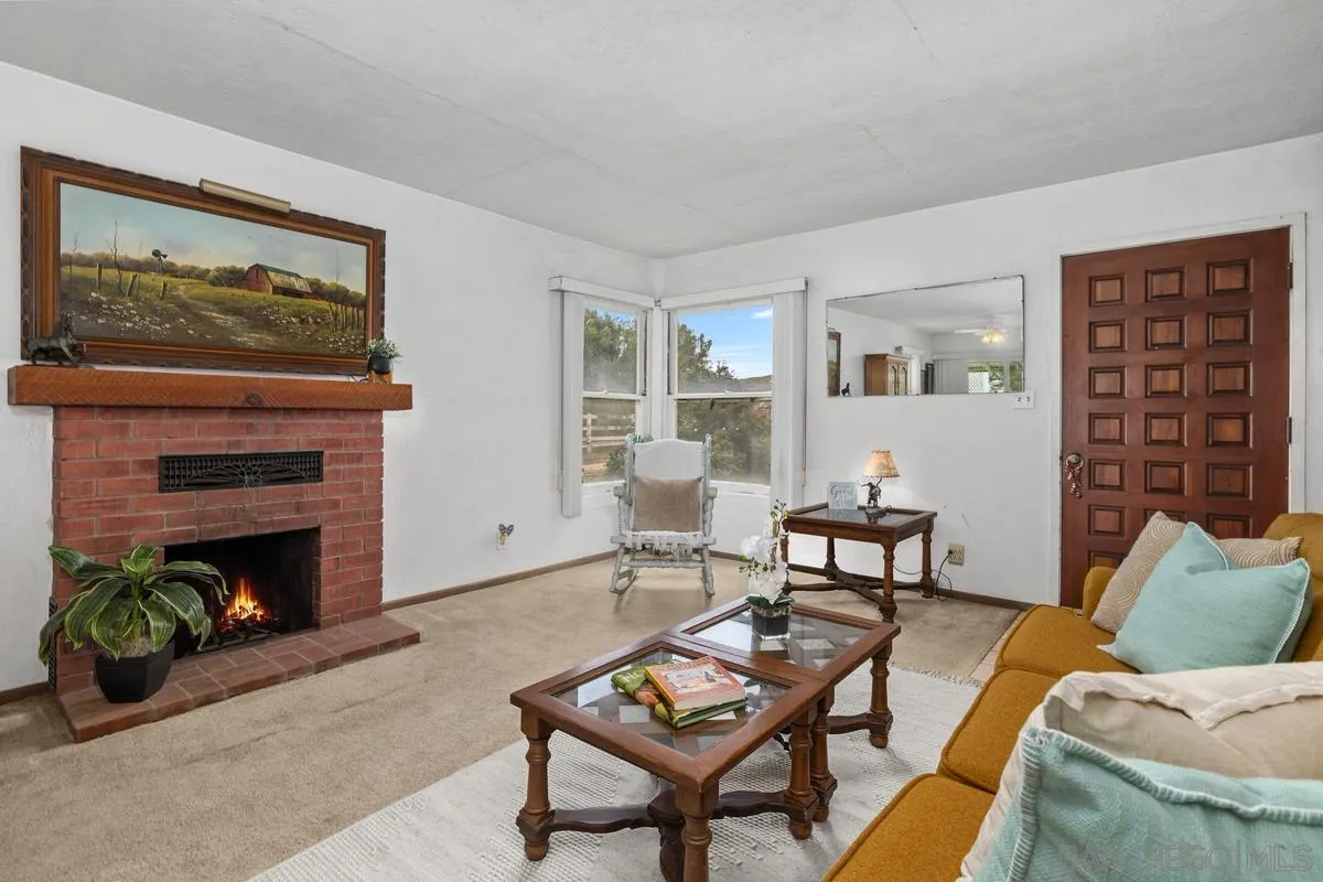 11179 Topo Lane Lakeside, CA 92040 - Photo 10 of 44 a living room with furniture a flat screen tv and a fireplace