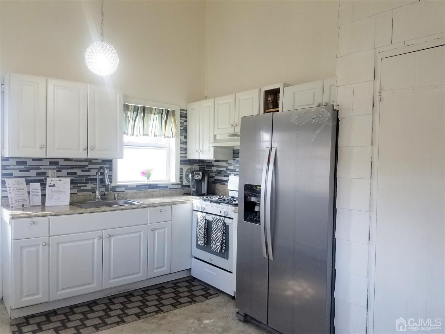 27 Eardley Road Edison, NJ 08817 - Photo 3 of 14 a kitchen with stainless steel appliances a refrigerator sink and cabinets