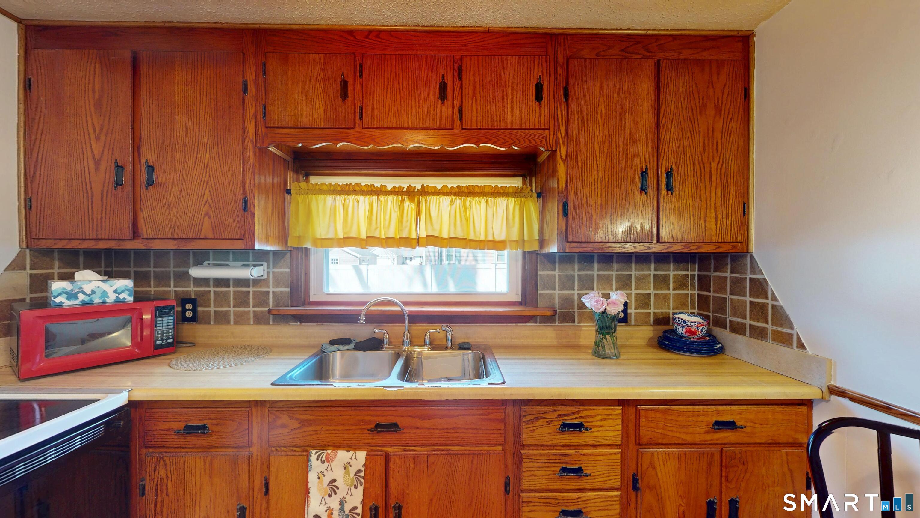 137 Brook Street Bristol, CT 06010 - Photo 21 of 37 a kitchen with stainless steel appliances wooden cabinets and a sink