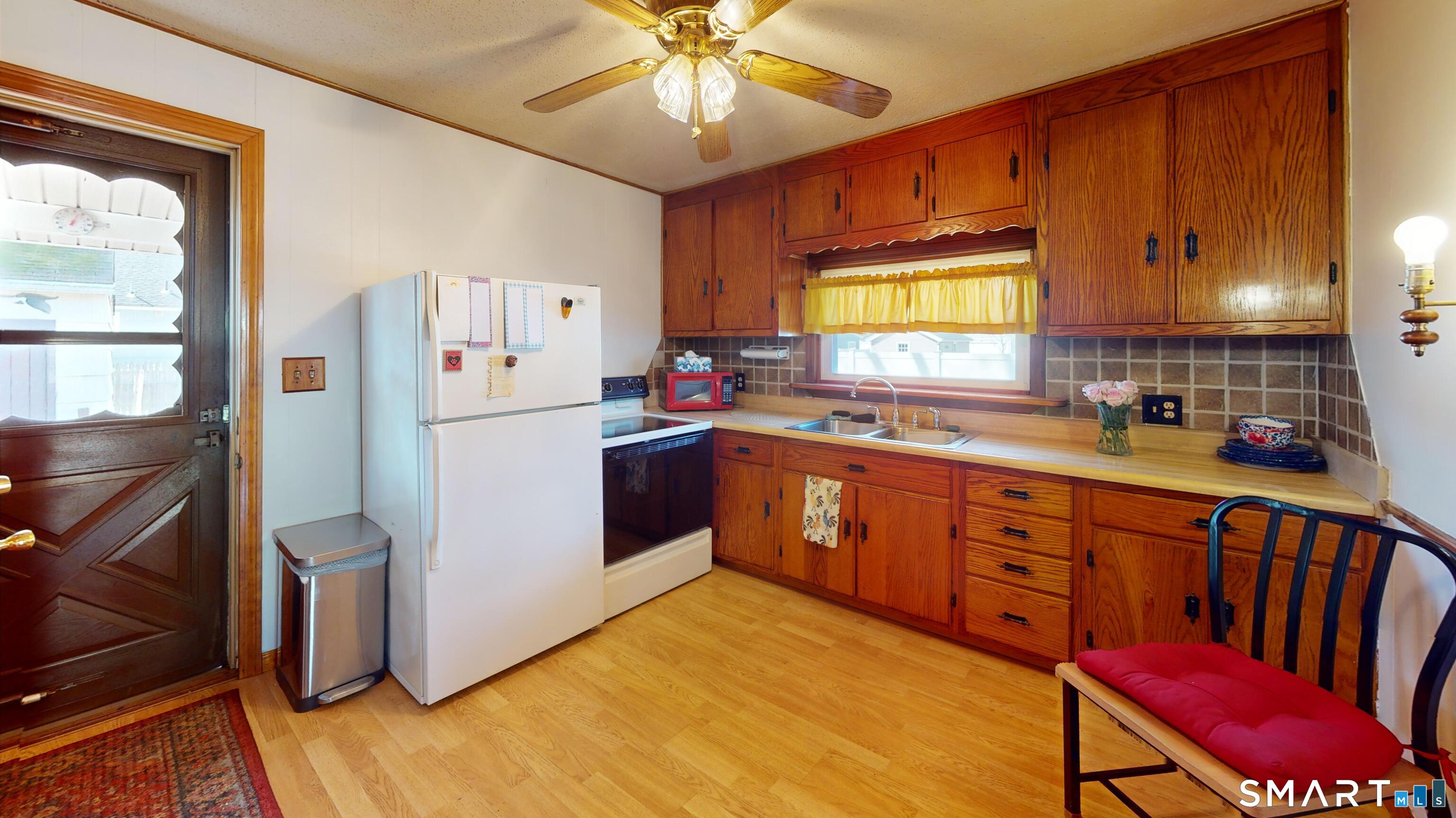 137 Brook Street Bristol, CT 06010 - Photo 22 of 37 a kitchen with stainless steel appliances sink stove refrigerator table and chairs